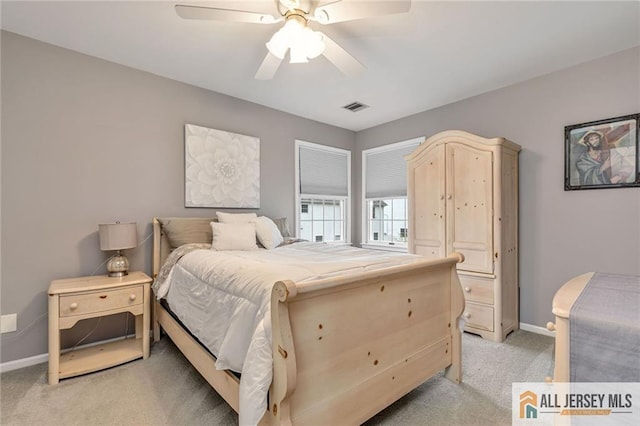 bedroom with light colored carpet, baseboards, and a ceiling fan