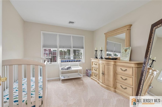 bedroom with light carpet and baseboards
