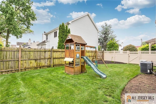 view of yard with cooling unit and a playground