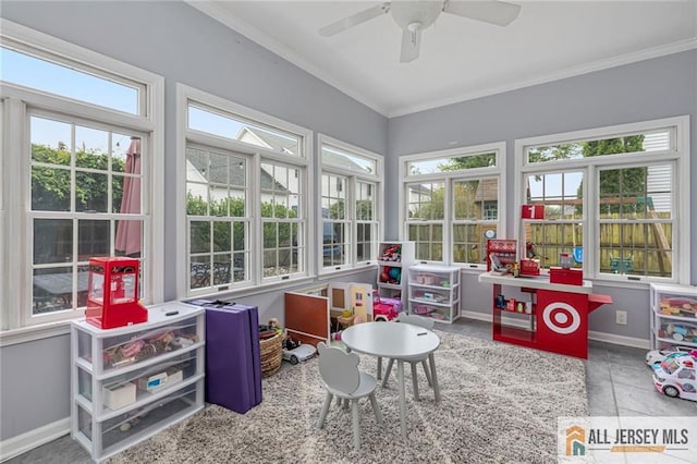 sunroom featuring healthy amount of natural light, ornamental molding, and baseboards