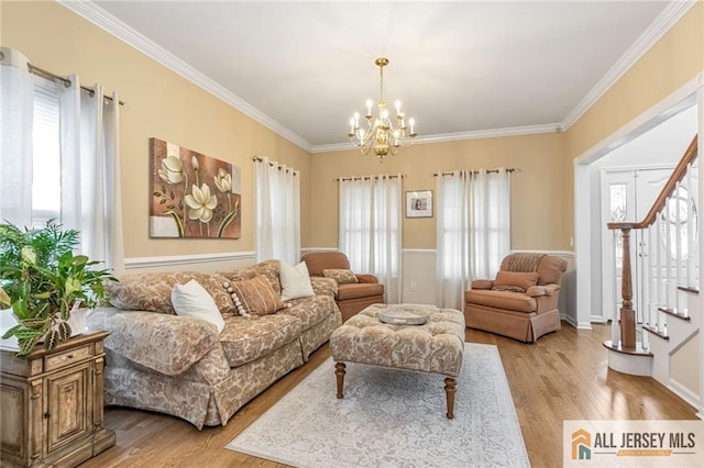 living area with light wood-style floors, a chandelier, stairway, and crown molding