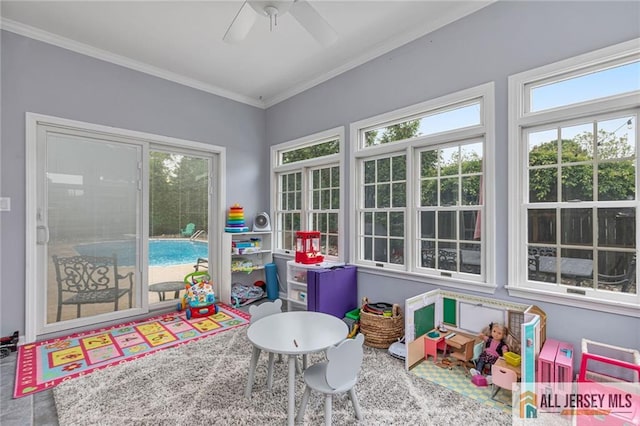 rec room with crown molding and a ceiling fan