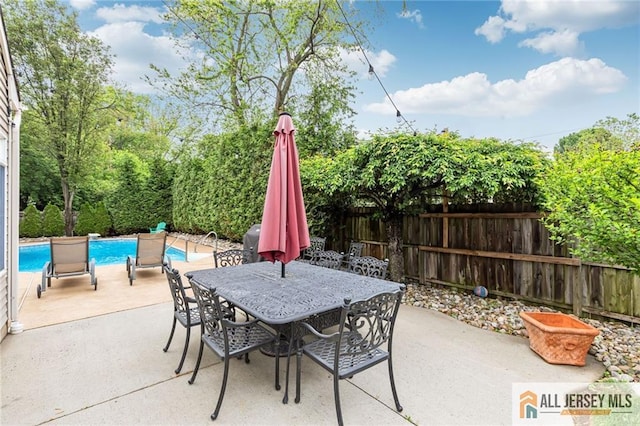 view of patio with fence and outdoor dining space