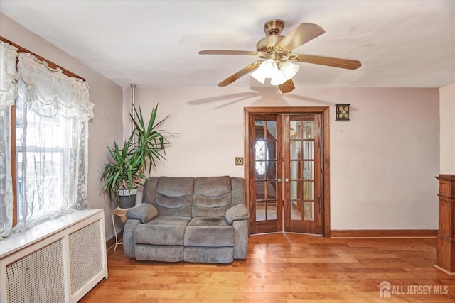352 Parker Ave, South Amboy, NJ 08879 - sitting room featuring radiator, light wood-type flooring, a ceiling fan, and baseboards
