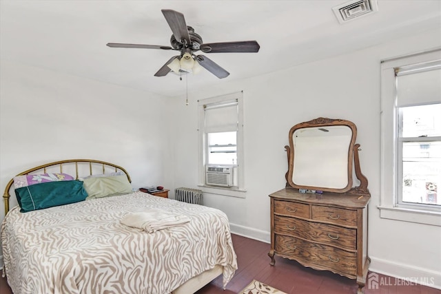 352 Parker Ave, South Amboy, NJ 08879 - bedroom with radiator heating unit, multiple windows, baseboards, and wood finished floors