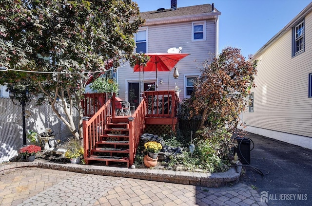 352 Parker Ave, South Amboy, NJ 08879 - back of property with stairway, a wooden deck, a chimney, and a patio area