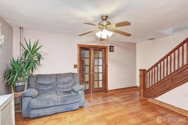 352 Parker Ave, South Amboy, NJ 08879 - living room with stairway, wood finished floors, ceiling fan, baseboards, and french doors