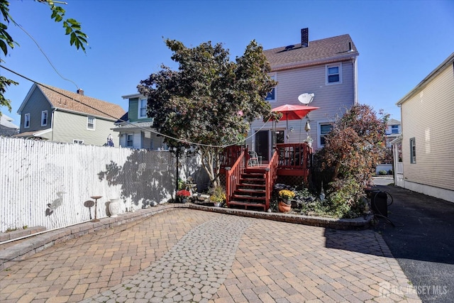 352 Parker Ave, South Amboy, NJ 08879 - back of property with a patio area, a wooden deck, and a chimney