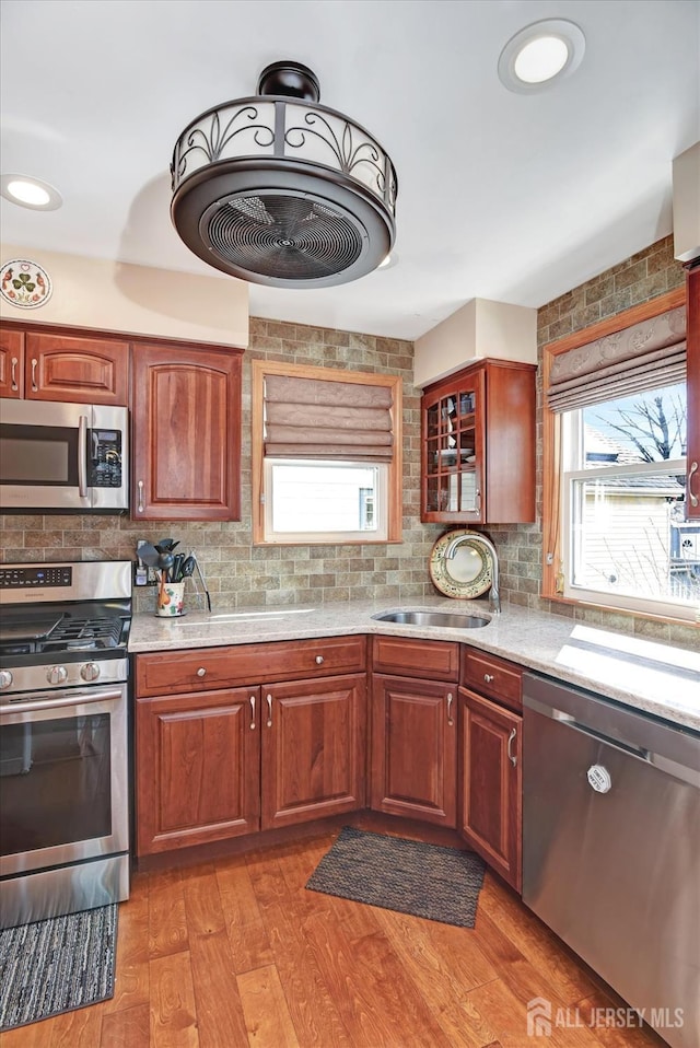 352 Parker Ave, South Amboy, NJ 08879 - kitchen with appliances with stainless steel finishes, a sink, light countertops, and decorative backsplash