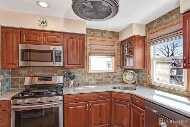 352 Parker Ave, South Amboy, NJ 08879 - kitchen featuring appliances with stainless steel finishes, a sink, plenty of natural light, and light stone counters