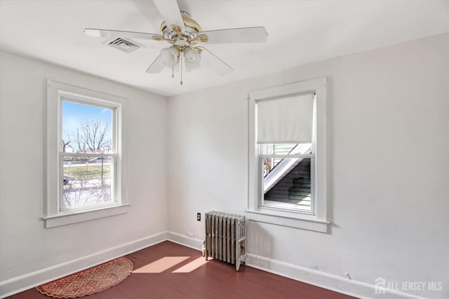 352 Parker Ave, South Amboy, NJ 08879 - unfurnished room with radiator heating unit, baseboards, dark wood-style flooring, and ceiling fan