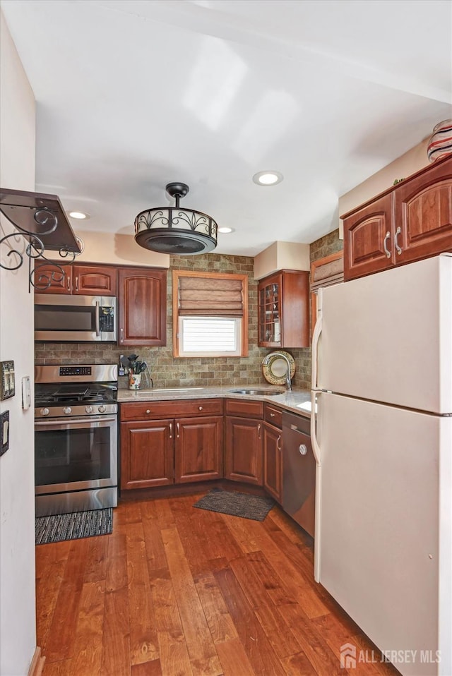 352 Parker Ave, South Amboy, NJ 08879 - kitchen featuring appliances with stainless steel finishes, a sink, dark wood-type flooring, decorative backsplash, and recessed lighting
