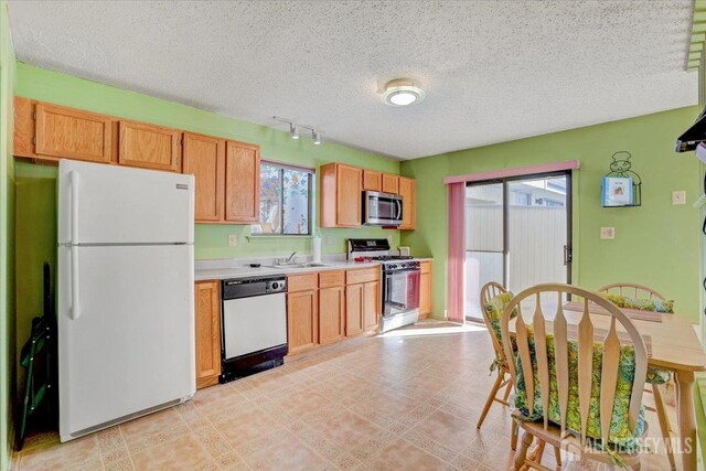 kitchen featuring sink, a textured ceiling, and appliances with stainless steel finishes