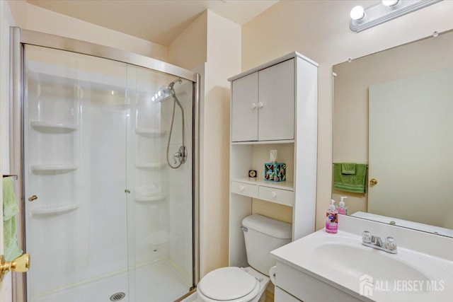 bathroom with vanity, an enclosed shower, and toilet