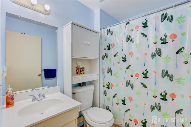 bathroom featuring vanity, toilet, and a shower with shower curtain