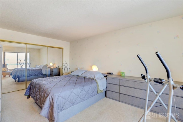 carpeted bedroom with a closet and a textured ceiling