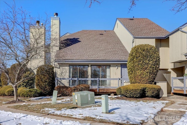 view of snow covered rear of property