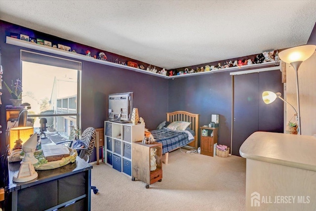 bedroom featuring carpet and a textured ceiling