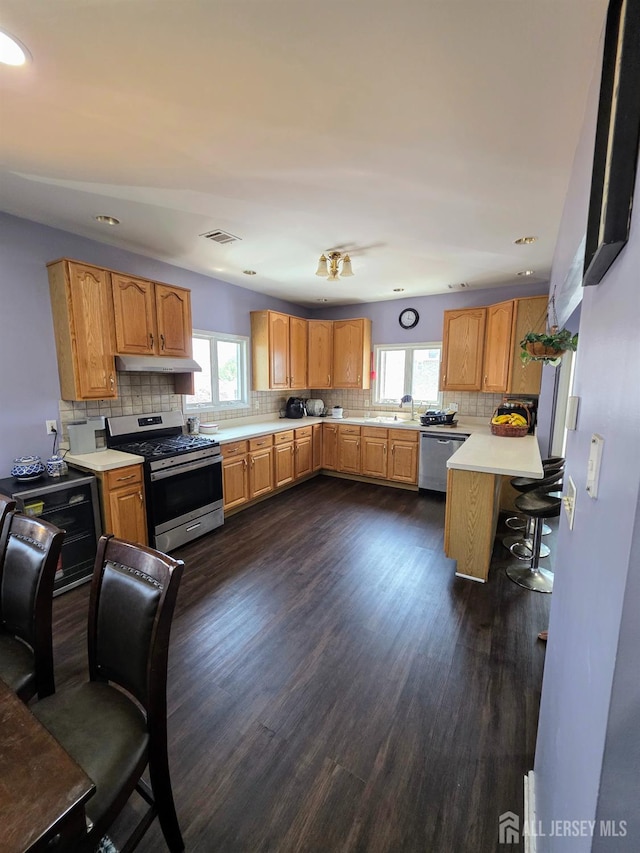 126 Holly St, Port Reading, NJ 07064 - kitchen with stainless steel appliances, plenty of natural light, under cabinet range hood, light countertops, and recessed lighting