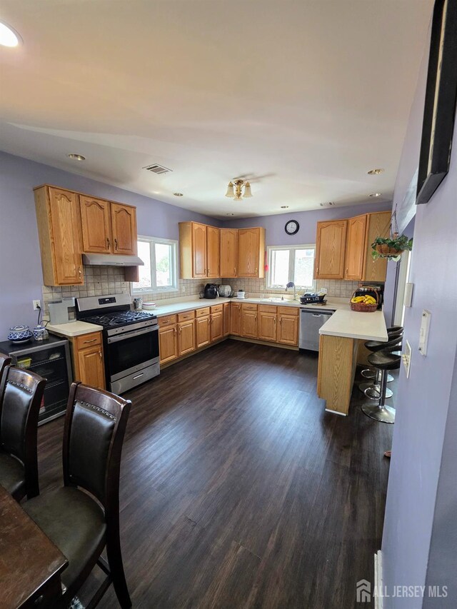 126 Holly St, Port Reading, NJ 07064 - kitchen featuring appliances with stainless steel finishes, plenty of natural light, under cabinet range hood, light countertops, and recessed lighting