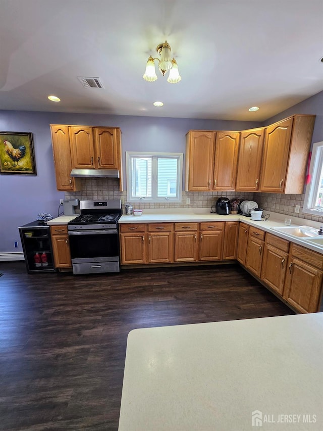 126 Holly St, Port Reading, NJ 07064 - kitchen featuring stainless steel gas range, under cabinet range hood, a sink, plenty of natural light, and recessed lighting
