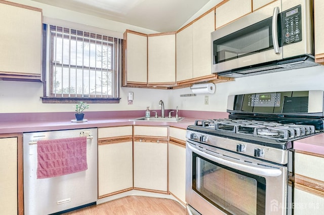 6 Schuyler Dr, Edison, NJ 08817 - kitchen featuring stainless steel appliances, a sink, cream cabinets, light countertops, and lofted ceiling