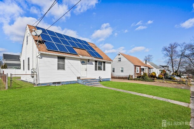 back of property with a yard and solar panels