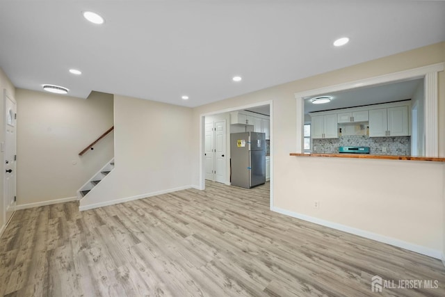 unfurnished living room featuring light wood-type flooring