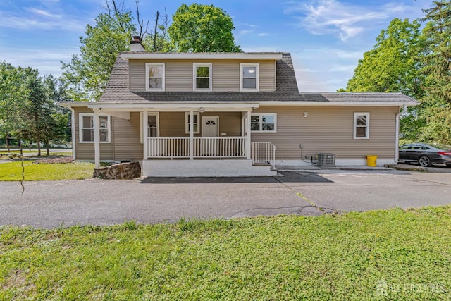 790 Ridge Rd, South Brunswick, NJ 08852 - view of front of property featuring a front yard, a porch, a chimney, and a shingled roof