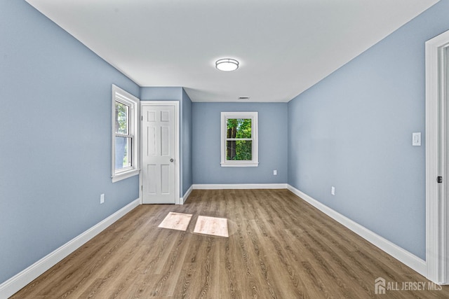790 Ridge Rd, South Brunswick, NJ 08852 - unfurnished bedroom with wood finished floors and multiple windows