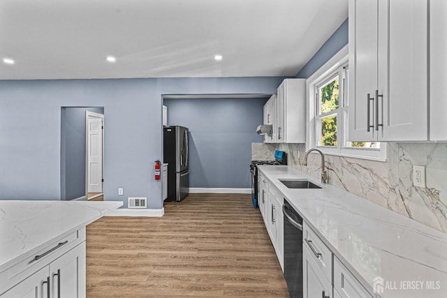 790 Ridge Rd, South Brunswick, NJ 08852 - kitchen featuring stainless steel appliances, white cabinets, recessed lighting, and light stone countertops
