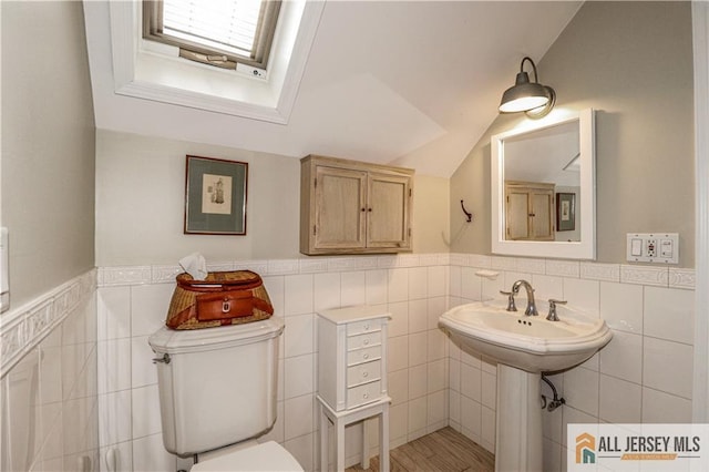 687 Spotswood-Englishtown Rd, Monroe, NJ 08831 - bathroom with tile walls, toilet, wainscoting, a skylight, and lofted ceiling