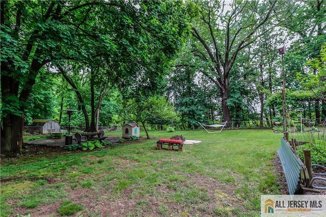 687 Spotswood-Englishtown Rd, Monroe, NJ 08831 - view of green lawn with a storage shed, an outdoor structure, and view of wooded area