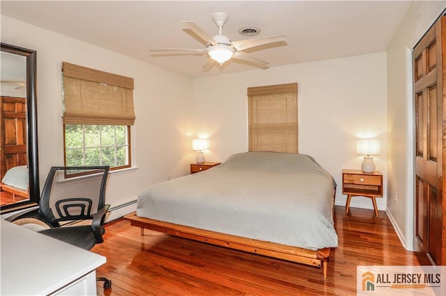 687 Spotswood-Englishtown Rd, Monroe, NJ 08831 - bedroom with wood finished floors, baseboards, ceiling fan, and a baseboard radiator