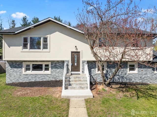 34 Hershey Rd, East Brunswick, NJ 08816 - bi-level home with a front lawn, stucco siding, and stone siding