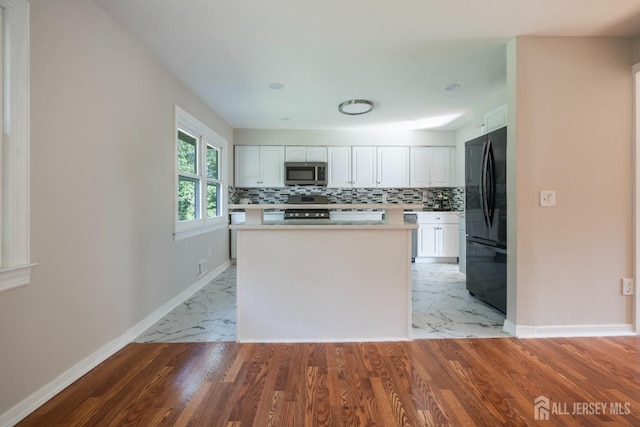 34 Hershey Rd, East Brunswick, NJ 08816 - kitchen featuring stainless steel microwave, freestanding refrigerator, stove, light countertops, and white cabinets
