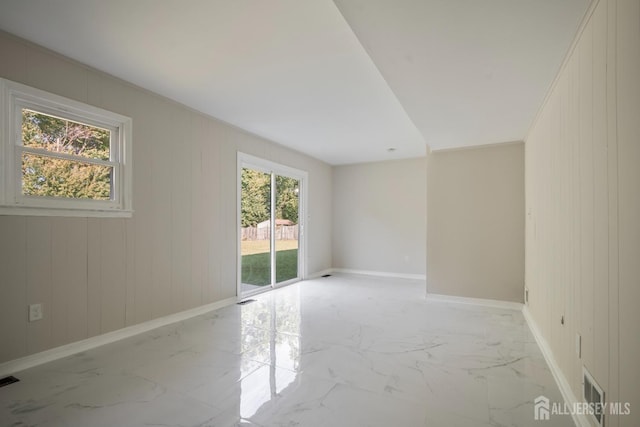 34 Hershey Rd, East Brunswick, NJ 08816 - spare room featuring baseboards, light marble finish floors, and wood walls