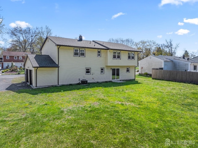 34 Hershey Rd, East Brunswick, NJ 08816 - rear view of property with a chimney, central AC, and a garage