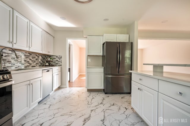 34 Hershey Rd, East Brunswick, NJ 08816 - kitchen featuring appliances with stainless steel finishes, light marble finish flooring, light countertops, and decorative backsplash