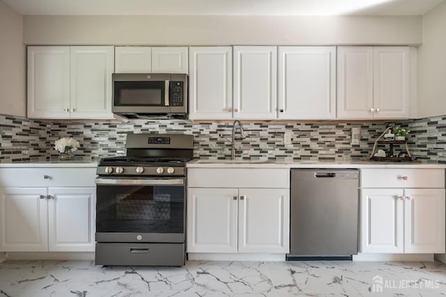 34 Hershey Rd, East Brunswick, NJ 08816 - kitchen featuring stainless steel appliances, light marble finish floors, and white cabinetry