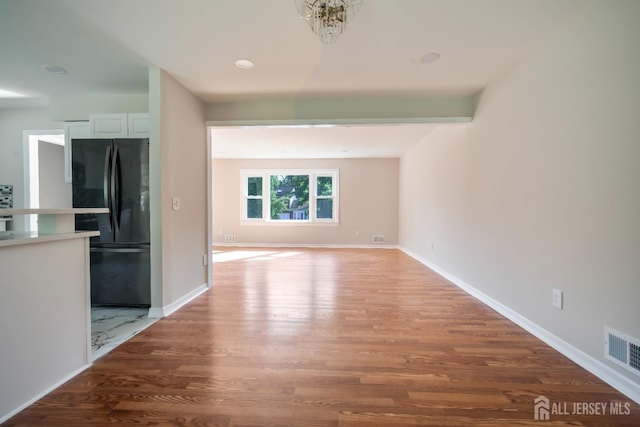 34 Hershey Rd, East Brunswick, NJ 08816 - unfurnished living room featuring wood finished floors and baseboards