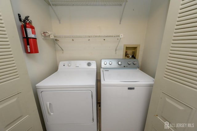 washroom featuring laundry area and washing machine and dryer