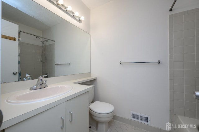 bathroom with toilet, bathing tub / shower combination, vanity, visible vents, and tile patterned floors