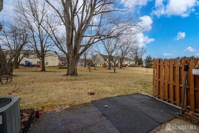 view of yard with cooling unit and fence