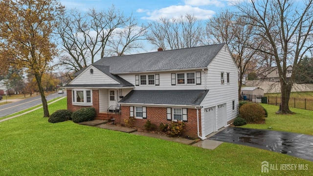 view of front of property featuring a front yard and a garage