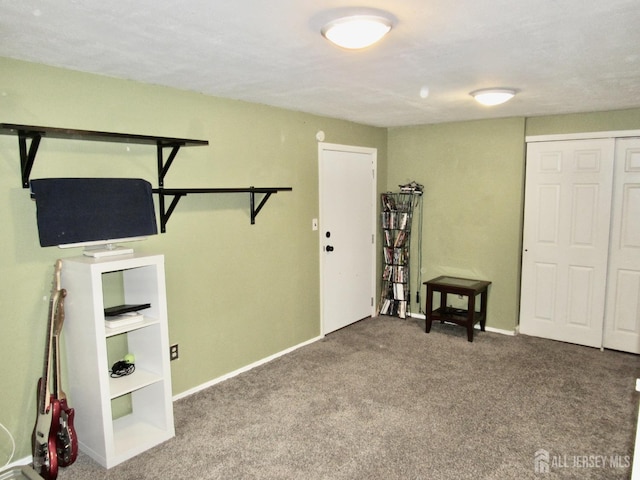 unfurnished bedroom featuring carpet floors and baseboards