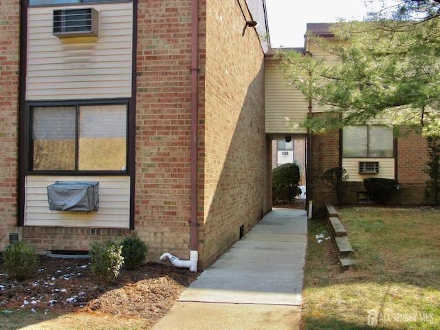 view of side of home with brick siding