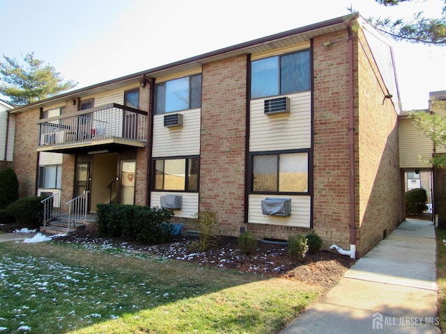 view of front of home with brick siding and a front lawn