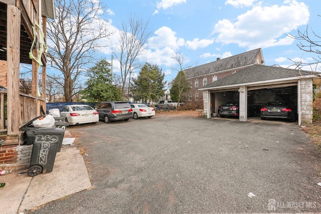 view of parking with fence