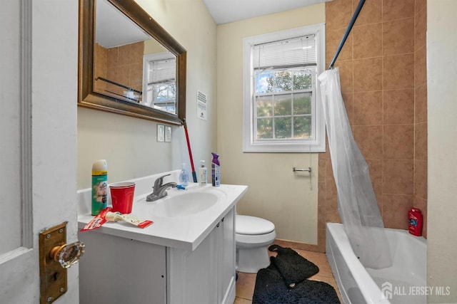 full bathroom featuring vanity, toilet, tile patterned flooring, and shower / bath combo